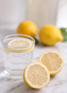 glass of water, with cut lemons