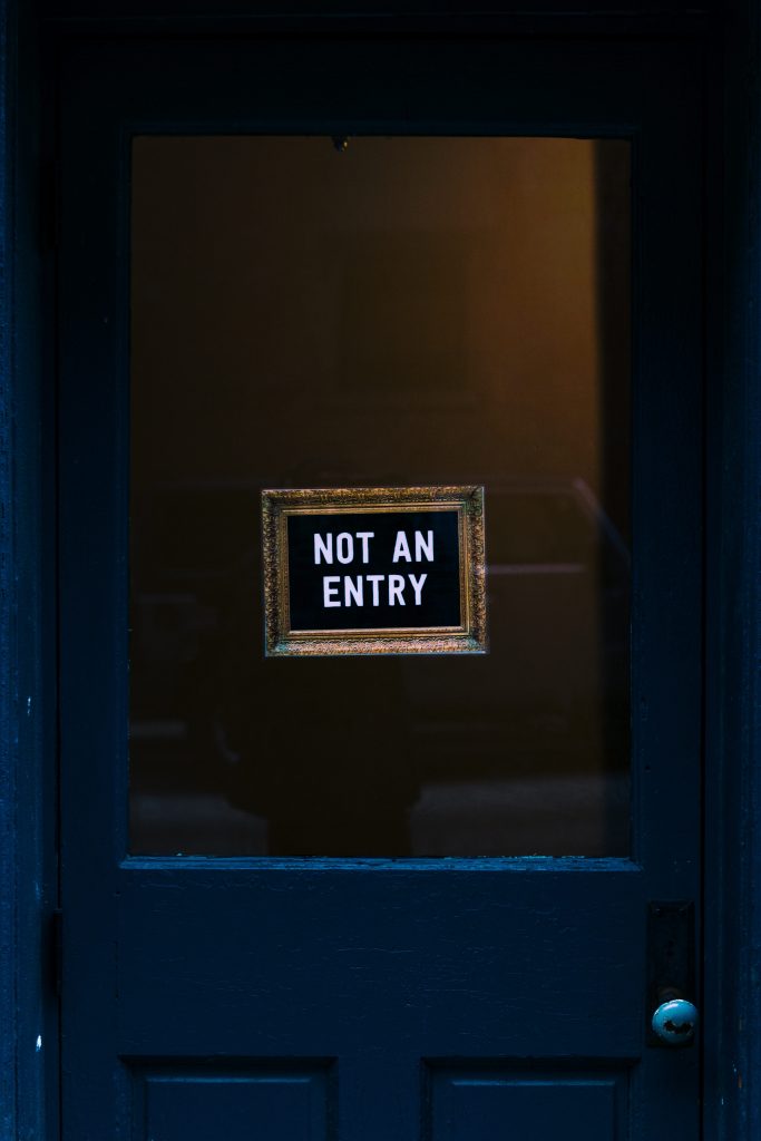 door with a sign stating "not an entry"