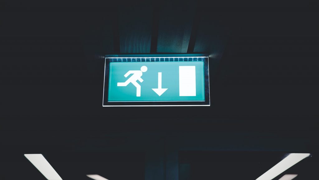 exit sign glowing in a dark space