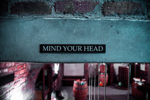 sign that states "mind your head"