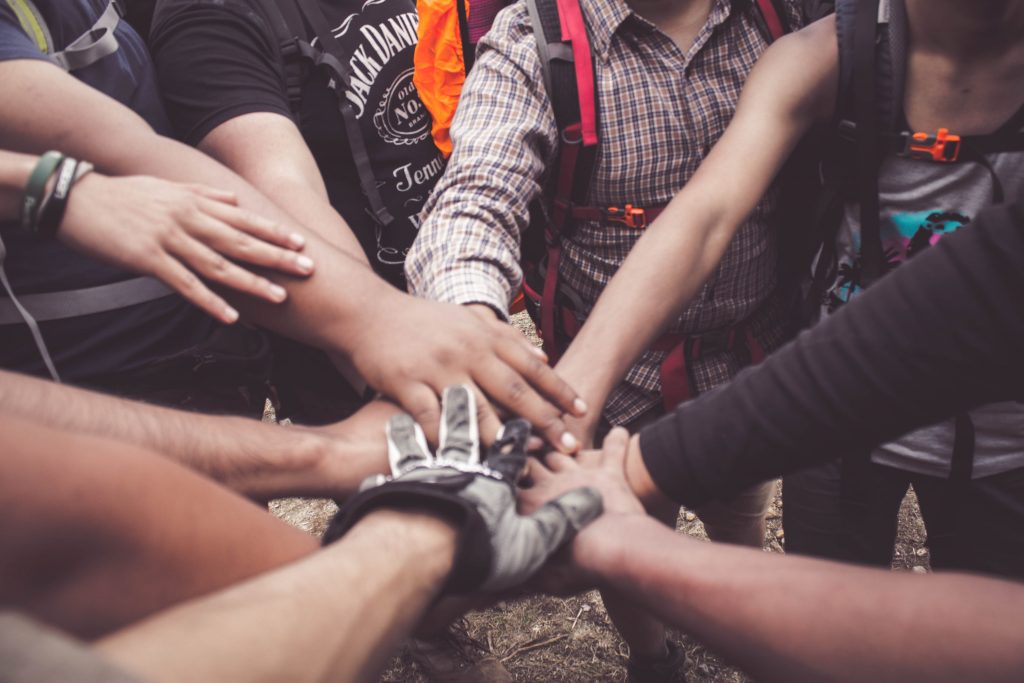 people doing a group hand cheer