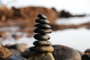 pebbles balancing on top of one another, at the sea side