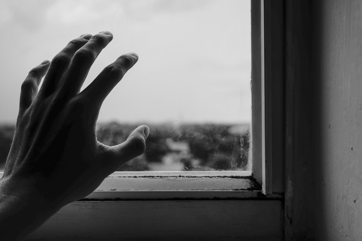 A hand reaching for window.