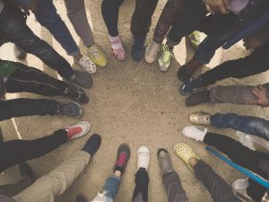 Group of people standing in a circle