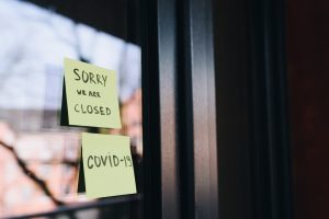 A shop with a closed sign on the window.