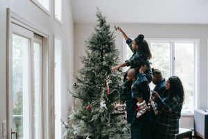 Family setting up Christmas Tree