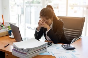 Business woman feeling stress from work in the office